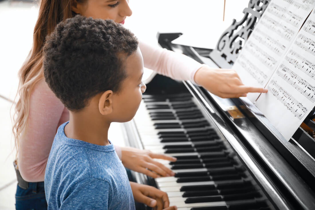 Boy learns piano